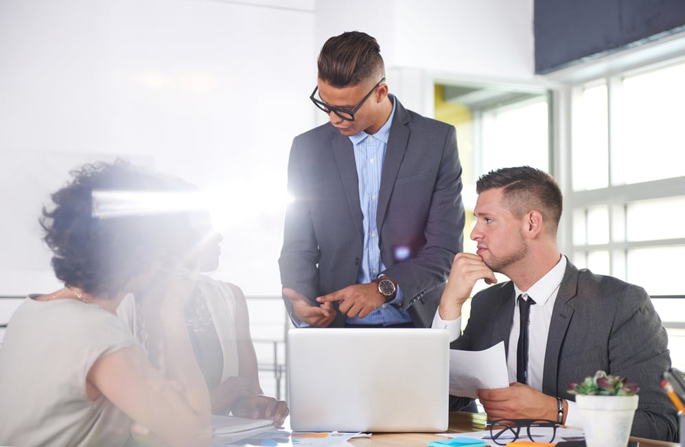 team of successful business people having a meeting in executive sunlit office